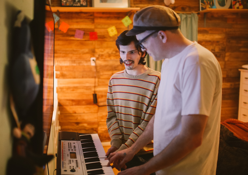 two people playing a keyboard