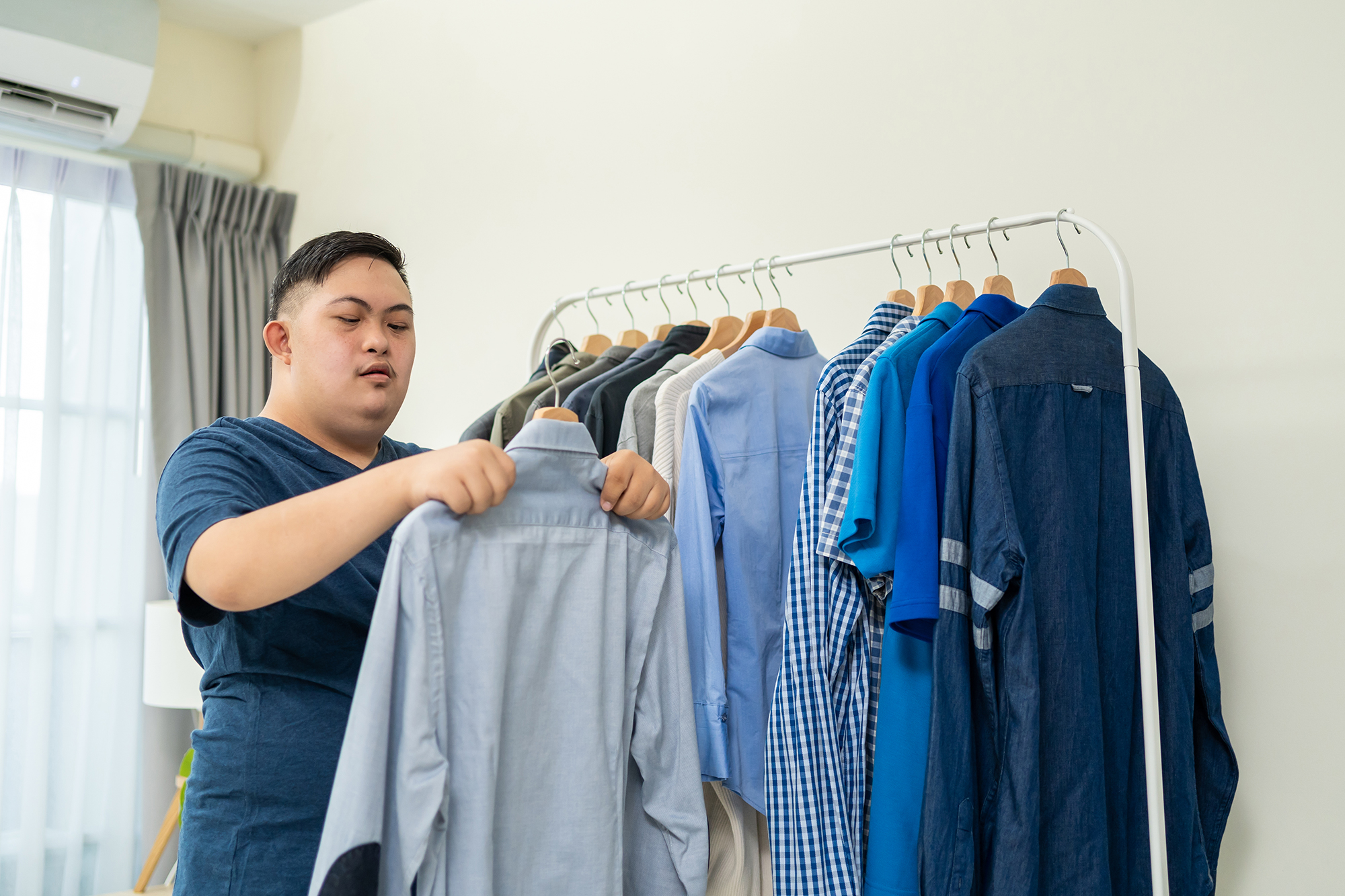 person choosing clothing from a rack