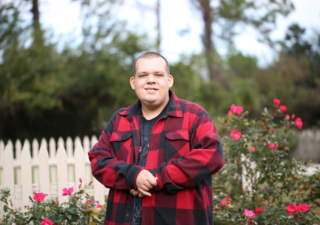 man standing in front of garden