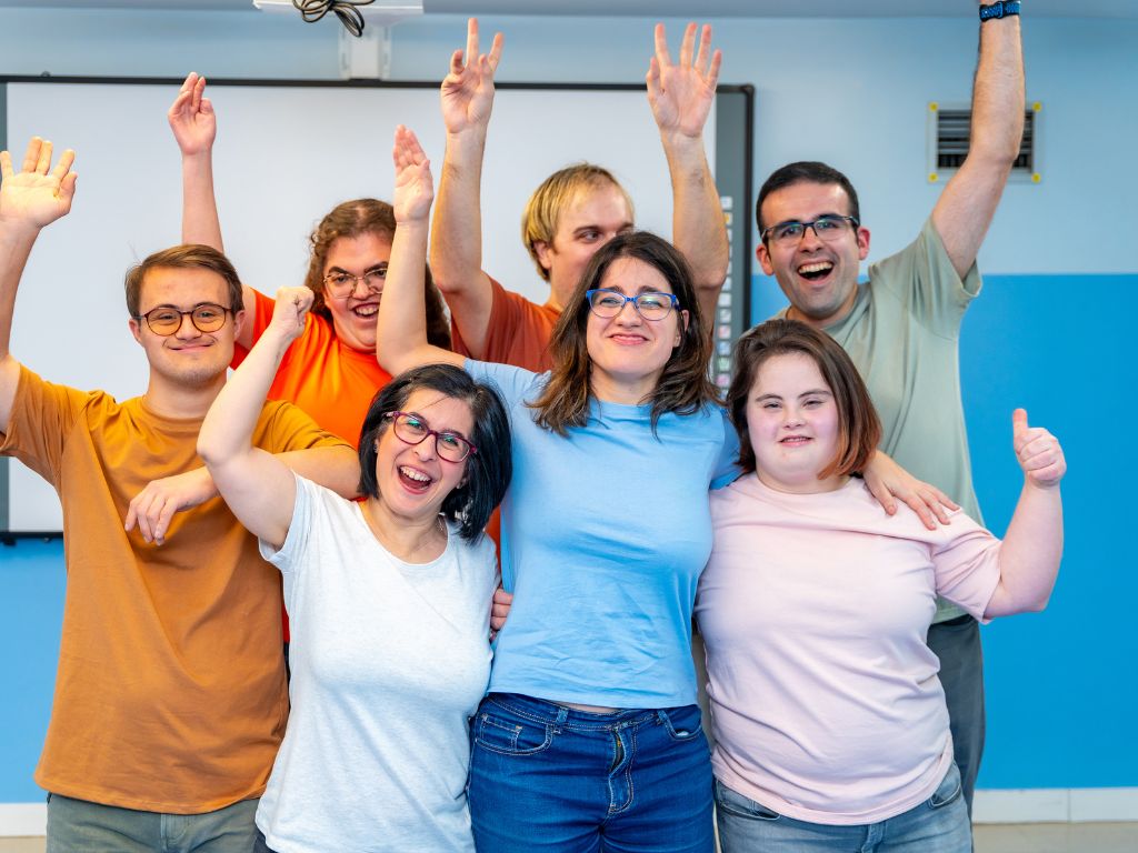 stock photo of a group of students with Down Syndrome celebrating