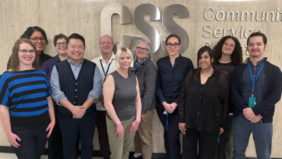 A photo of all the IDDO staff members in front of a large sign that says CSS