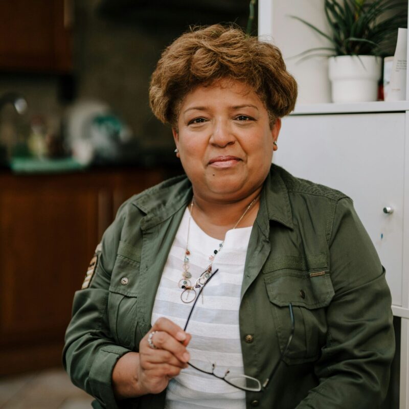 person holding glasses and holding a tablet